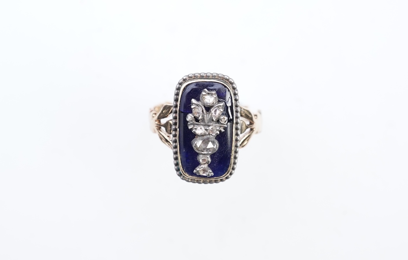 A diamond and blue glass ring